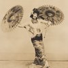 Doris Humphrey in oriental costume holding parasols 