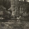 Four figures in a canoe on the water