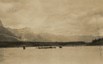 Group of travelers on horseback fording river