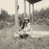 Frederick V. Field and young woman sitting on porch