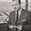 Walter Cronkite holding model airplane