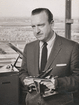 Walter Cronkite holding model airplane