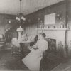 Meta Warrick Fuller in her living room on Warren Drive, Framingham, Massachusetts. "Four Seasons" sculpture over mantle in fireplace.