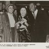 Upon arrival at the Tokyo airport, Louis and Lucille Armstrong are being greeted by Miss Mizushima, a Japanese singer