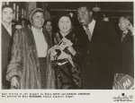 Upon arrival at the Tokyo airport, Louis and Lucille Armstrong are being greeted by Miss Mizushima, a Japanese singer
