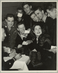 Kitty Carlisle surrounded by service men