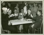 Service men seated at table having coffee