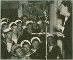 Service men watching Gracie Fields sing on stage
