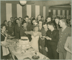 Woman offering a slice of cake to sailor