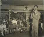 Frank Sinatra surrounded by audience.