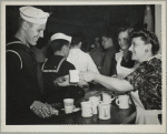 Bea Lille handing out coffee to a sailor