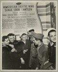 Service men standing in front of sign