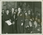 Helen Menken, Mrs. Roosevelt and Milton Berle at CBS microphone surrounded by service men.