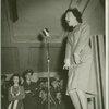 Woman on stage performing for service man at Stage Door Canteen.