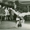 Female dancers performing for service men and hostesses