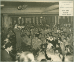 "Harry James with his 'secret weapon'" - Harry James plays the trumphet on stage at the Stage Door Canteen (Newark).