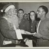 Santa shares a laugh with a service man