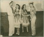 Bette Davis and Helen Menken shaking hands with service men.