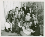 Yul Brynner (The King), Constance Carpenter (Anna Leonowens replacement) and children of The King and I at a Christmas party