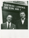 Richard Rodgers (music) and Oscar Hammerstein II (lyrics) standing in front of the St. James Theatre marquee for The King and I