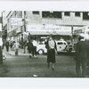 Woman crossing street in Harlem at West 125th Street and Eighth Avenue, 1939