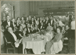 Tatiana Chamié in a group photo around dining table