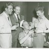 George Britton (Emile De Becque replacement), William Hammerstein, Martha Wright (Nellie Forbush replacement) and Myron McCormick (Luther Billis) at McCormick's birthday celebration in his dressing room at South Pacific