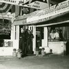 Gray Shop No. 2 Southern-style restaurant, with two sailors and third individual posing in the doorway, ca. 1939