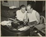 Ted Husing in T-shirt (right) with unidentified man leaning over him