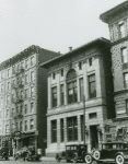 Exterior view of the 135th Street Branch of the New York Public Library, ca. 1930s. The Nail & Parker Building is on the left