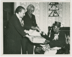 Mrs. Emma English declared Mother of the Year by New Jersey Civil Rights Congress, receiving gifts from Mr. Joseph Collins, community leader, Trenton, and Mrs. Remel Roberson, church leader and newspaperwoman, May 1950