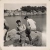 Young men sunning on a rock