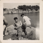 [Young men sunning on a rock]