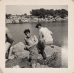 Young men sunning on a rock