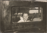 Migrant worker looking through back window of automobile near Prague, Oklahoma. Lincoln County, Oklahoma