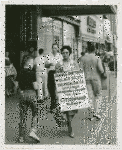 Daisy Bates takes a walk - Activist Daisy Bates picketing with placard