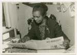 Claudia Jones reading the West Indian Gazette, London, 1960s