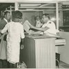 Primary Inspection Booth, Miami International Airport. Immigrant Inspector conducts primary inspection of arriving immigrant