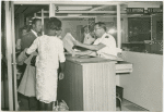 Primary Inspection Booth, Miami International Airport. Immigrant Inspector conducts primary inspection of arriving immigrant.