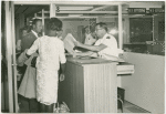 Primary Inspection Booth, Miami International Airport. Immigrant Inspector conducts primary inspection of arriving immigrant
