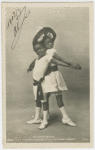 Le Cake-Walk."Danse au Nouveau Cirque, LES ENFANTS NEGRES." Photo postcard of young boy and girl in dance pose, back to back, clasping hands.