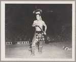 Tom Two Arrows performing before an audience in Asia