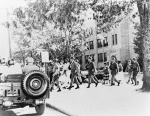 Nine students leave Central High, Little Rock, Arkansas, under U.S. Army escort