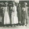 Four women, three wearing shawls