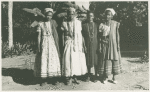 Four women, three wearing shawls