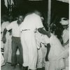 Participants at ceremony, man supporting a woman