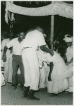 Participants at ceremony, man supporting a woman