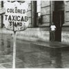 View of street showing segregated taxi cab sign