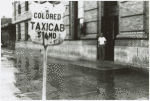 View of street showing segregated taxi cab sign