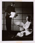 Man with fan in a scene from Deshima